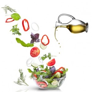 Falling vegetables for salad and oil isolated on white